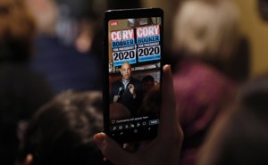 Cory Booker, seen through a cellphone, speaking in Marshalltown, Iowa