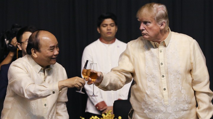 Vietnam's prime minister, Nguyen Xuan Phuc, and Donald Trump raise a glass at the Association of Southeast Asian Nations meeting in Manila in November 2017.