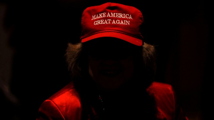 A Trump supporter wears a "Make America great again" hat