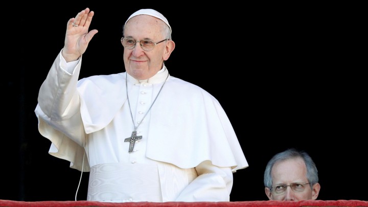 Pope Francis waves from the balcony of Saint Peter's Basilica at the Vatican on Christmas in 2018.