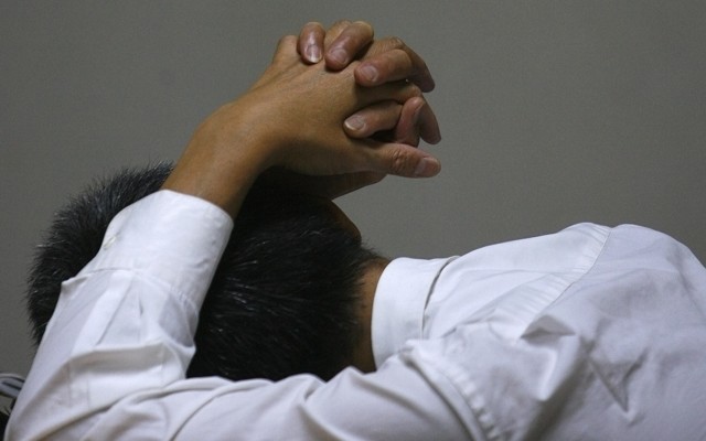 A man sleeps at his desk.