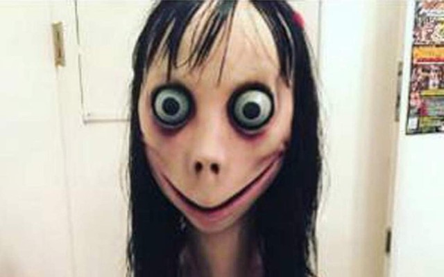 The "Momo"/"Mother Bird" sculpture of a face with bulging eyes and a wide, threatening grin