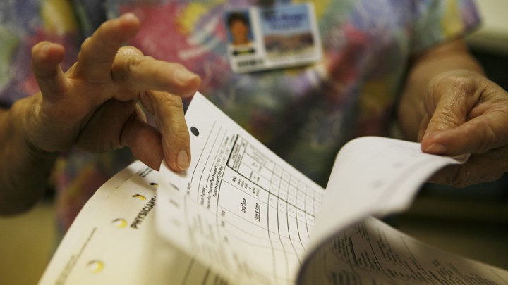 Hands flipping through medical records
