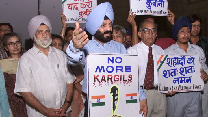 Family members and friends of Indian soldiers killed in the Kargil conflict gather on the conflict's first anniversary, in 2000.