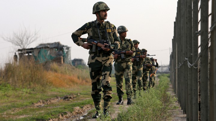 India's Border Security Force soldiers patrol along the fenced border with Pakistan on February 26, 2019.