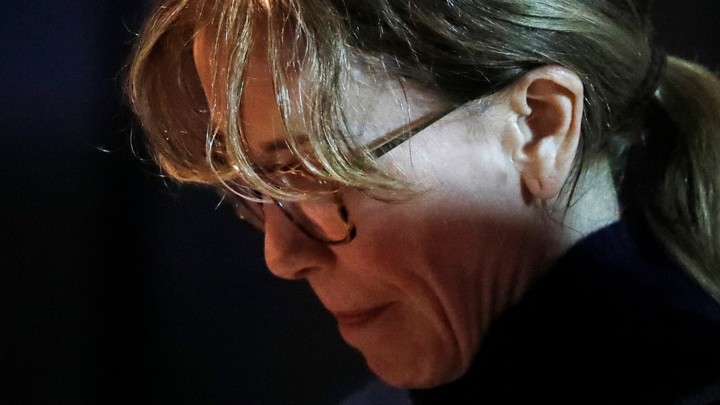 Felicity Huffman departs an initial hearing for defendants in the college-bribery case.