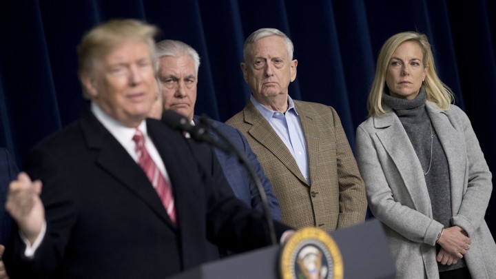 Rex Tillerson, James Mattis, and Kirstjen Nielsen watch Donald Trump.