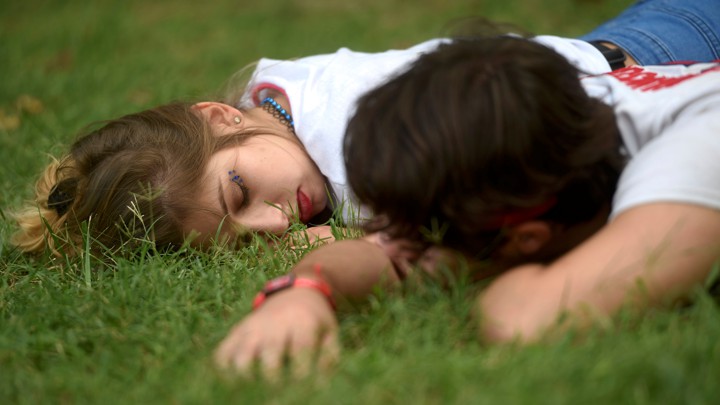 A couple sleeping in the grass