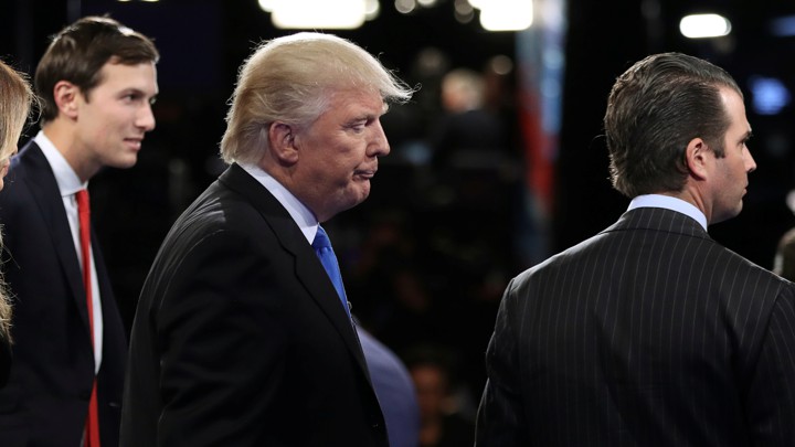 Donald Trump is flanked by his son-in-law, Jared Kushner, and his son Donald Trump Jr.