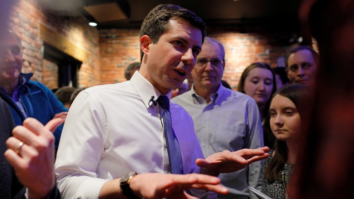 Pete Buttigieg speaks with a small cluster of people.