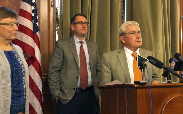 Andy McKean, right, the longest-serving Republican in the Iowa legislature, announced that he's becoming a Democrat during a news conference on April 23, 2019.