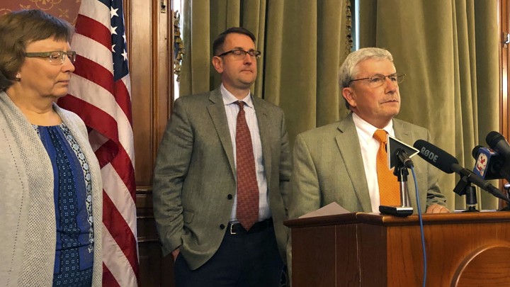 Andy McKean, right, the longest-serving Republican in the Iowa legislature, announced that he's becoming a Democrat during a news conference on April 23, 2019.