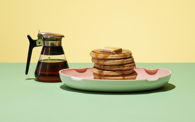 A stack of pancakes and syrup