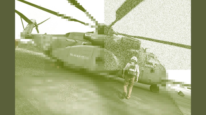 A man walks toward a helicopter