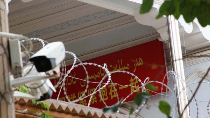A propaganda banner and a security camera are placed on the walls of a mosque in the Old City in Kashgar, Xinjiang Uighur Autonomous Region, on September 6, 2018