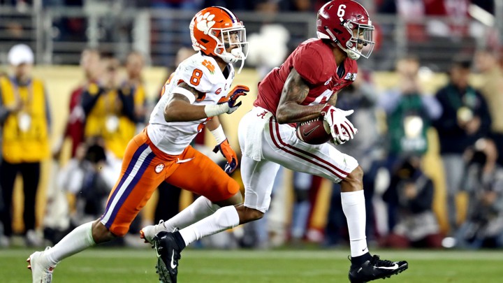 Two college football players mid-game