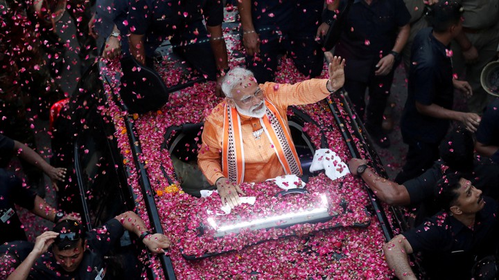 Narendra Modi waves to supporters in Varanasi in April.