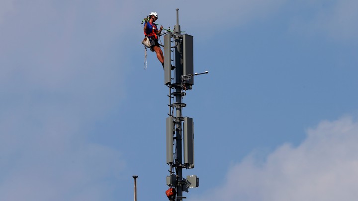 A worker atop a mobile-phone tower
