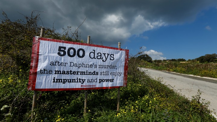 A sign reading "500 days after Daphne's murder, the masterminds still enjoy impunity and power" marks the location of Daphne Caruana Galizia's murder.