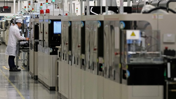 An employee works on a mobile-phone production line at Huawei's factory campus in Dongguan, Guangdong province, China on March 25, 2019.