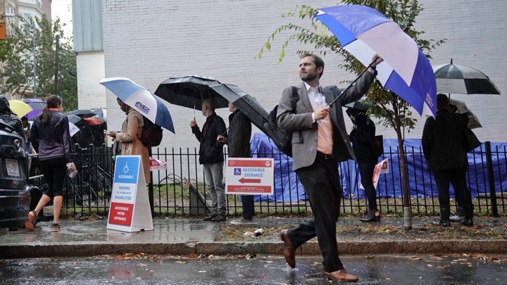 Washington, D.C., voters line up in the rain to cast a ballot in the 2018 midterm elections.