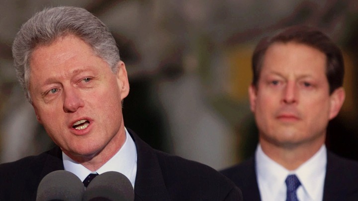 Bill Clinton speaking with Al Gore in the background