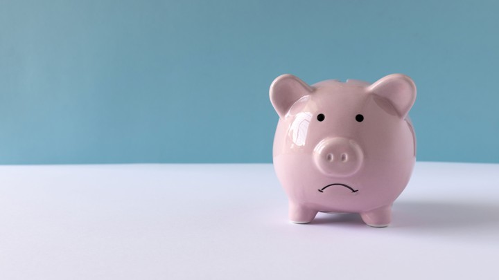 A piggy bank with a frowning face