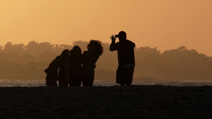 Man taking a photo of a group with a smartphone
