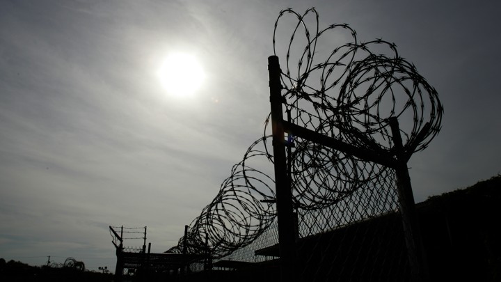 A rusting fence with barbed wire