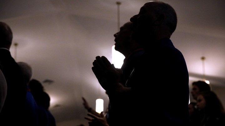 Members of a Baptist church pray.