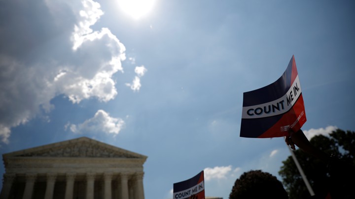 A protester holds a sign outside the U.S. Supreme Court today, when the court ruled that President Donald Trump's administration did not give an adequate explanation for its plan to add a citizenship question to the 2020 census.