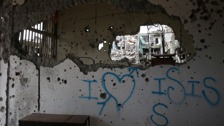 Graffiti that reads "I love ISIS" is seen in a damaged building in Marawi City, Philippines.