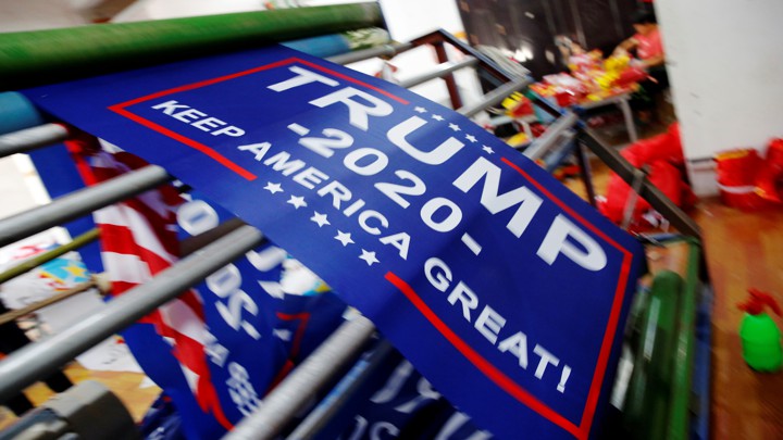 Flags for Donald Trump's reelection campaign at a factory in China in 2018