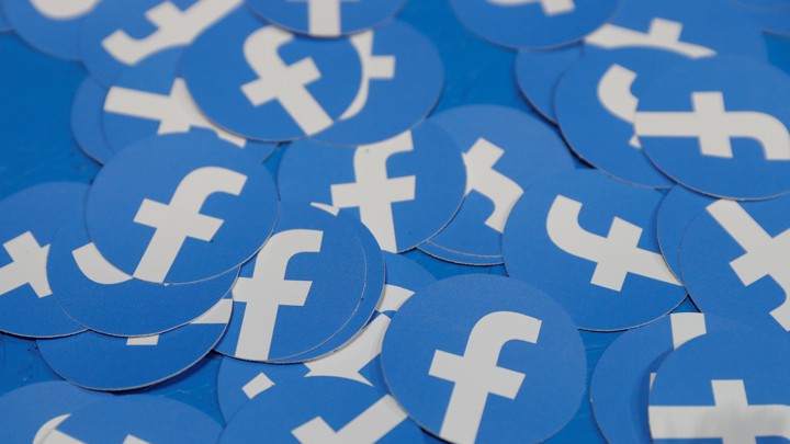 A pile of stickers bearing the Facebook logo