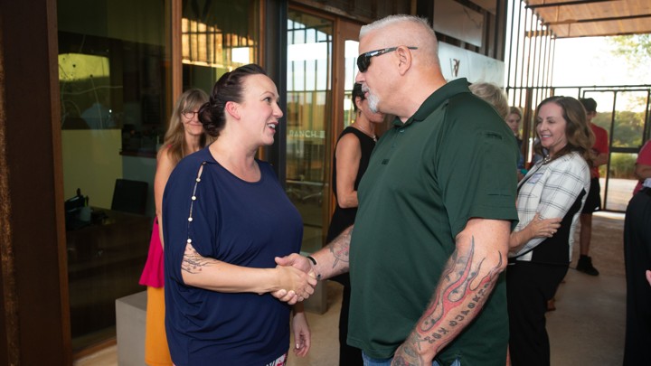 M. J. Hegar, a candidate for Senate in Texas, shakes hand with a voter.