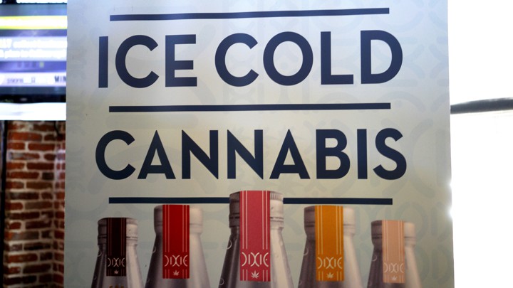 A banner hangs at the Dixie Elixirs company booth at the CannaSearch cannabis-industry job fair in downtown Denver on September 16, 2014.