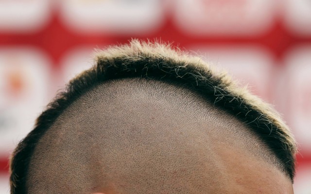 A close-up of a person's short mohawk