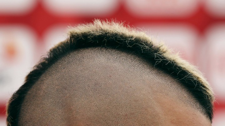 A close-up of a person's short mohawk