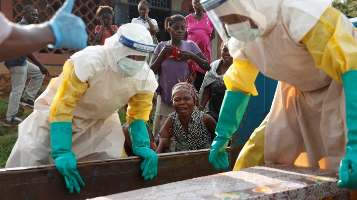 A mother of a child, suspected of dying from Ebola, cries near her child's coffin in Beni
