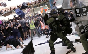 Hong Kong riot police use pepper spray to disperse protesters in a suburban shopping mall.