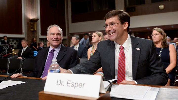 Senator Tim Kaine speaks with Mark Esper, then the nominee for defense secretary, before a Senate Armed Services Committee hearing on Esper's nomination on July 16.