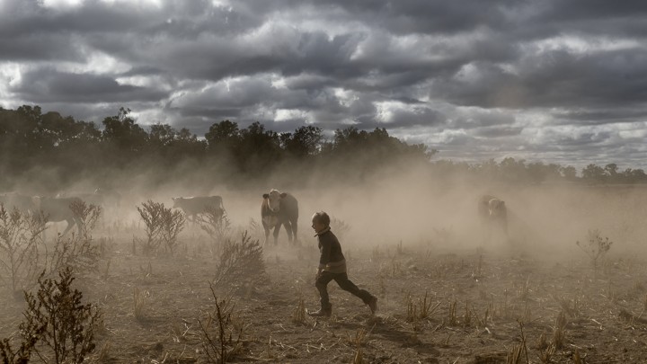 Harry Taylor plays on the dust bowl his family farm has become during the drought, in the Central Western region of New South Wales, Australia.