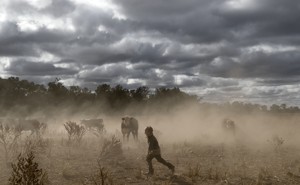 Harry Taylor plays on the dust bowl his family farm has become during the drought, in the Central Western region of New South Wales, Australia.