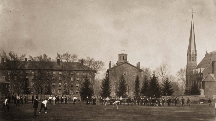 People stand on Wesleyan's college quad, near the campus's gothic Memorial Chapel.