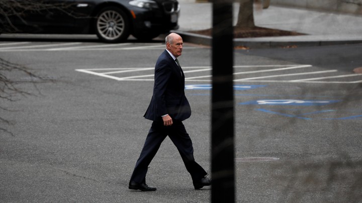 A long shot of Dan Coats walking through an empty parking lot.