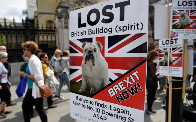 People walk past pro-Brexit placards in central London.