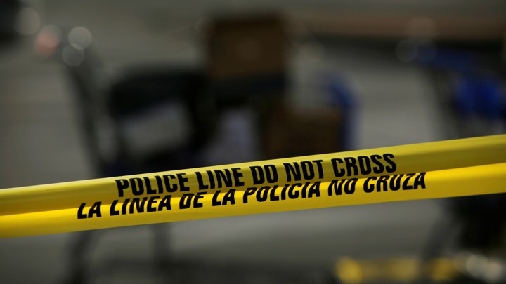 A yellow-and-black police cordon is seen after a mass shooting in El Paso, Texas.