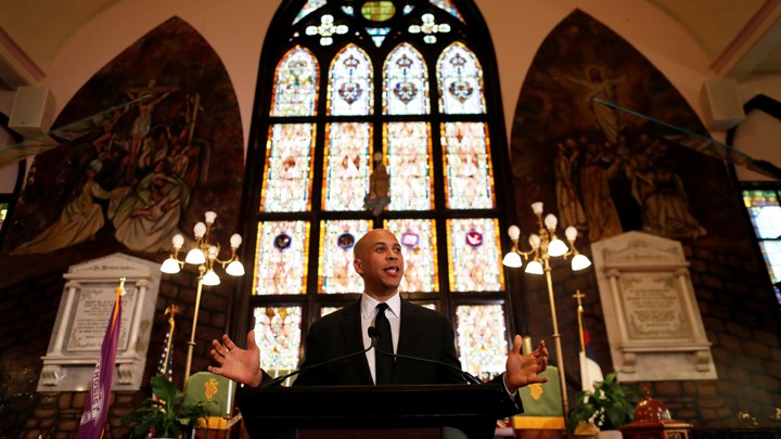 Cory Booker stands in front of a church tabernacle while speaking at the Mother Emanuel church in South Carolina.