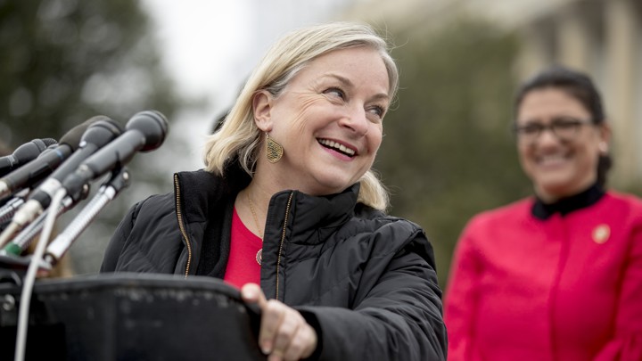 Representative Susan Wild , left, accompanied by Rep. Rashida Tlaib, D-Mich., right, laugh as she takes the podium to speak at a news conference on Capitol Hill in Washington, Thursday, Jan. 17, 2019
