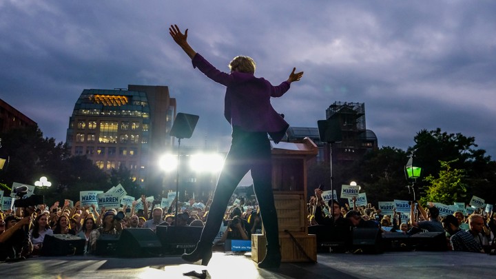 Elizabeth Warren embraces supporters at a New York City rally.